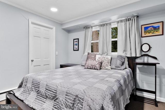 bedroom with crown molding and carpet