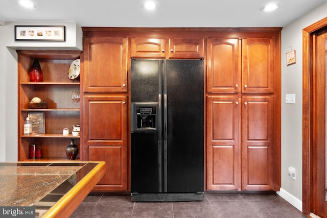 kitchen featuring black fridge and dark tile patterned floors