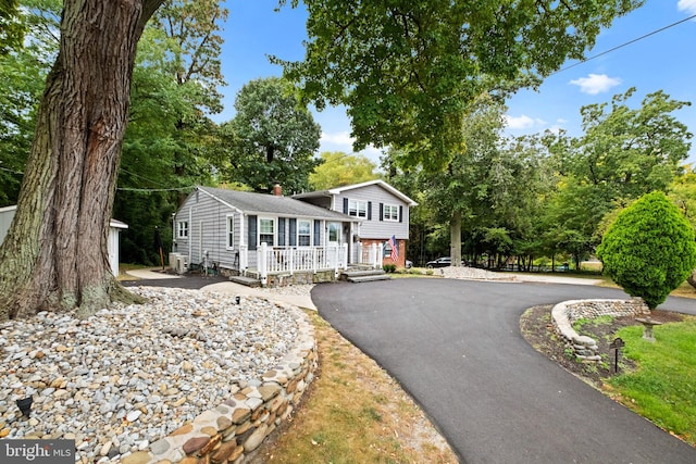 split level home with covered porch