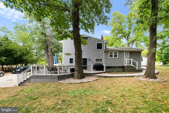 rear view of property featuring a lawn