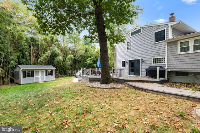 view of yard with a shed and a deck