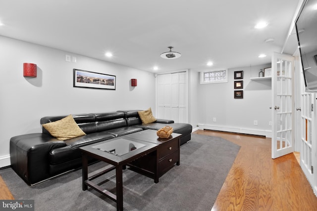 living room with hardwood / wood-style floors and a baseboard heating unit