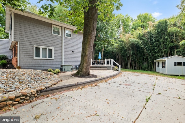 view of side of home with a storage unit