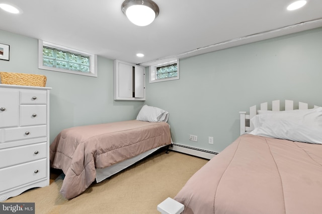 bedroom featuring baseboard heating and light carpet