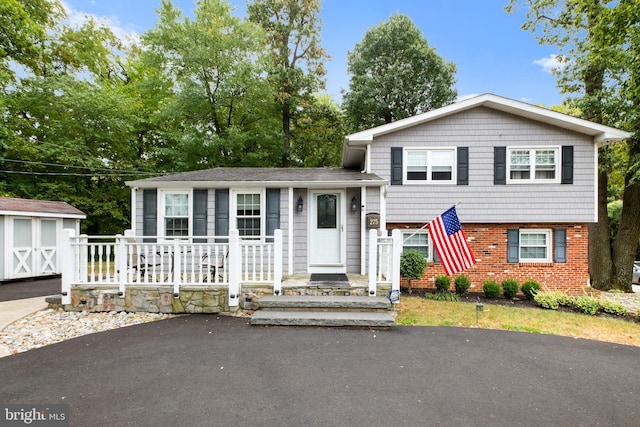 split level home with a storage shed