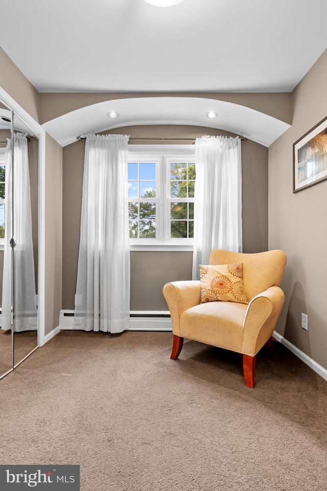 sitting room with carpet and a baseboard radiator