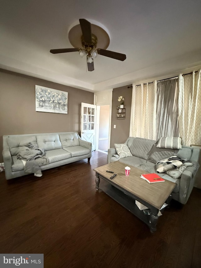 living room featuring dark hardwood / wood-style flooring and ceiling fan