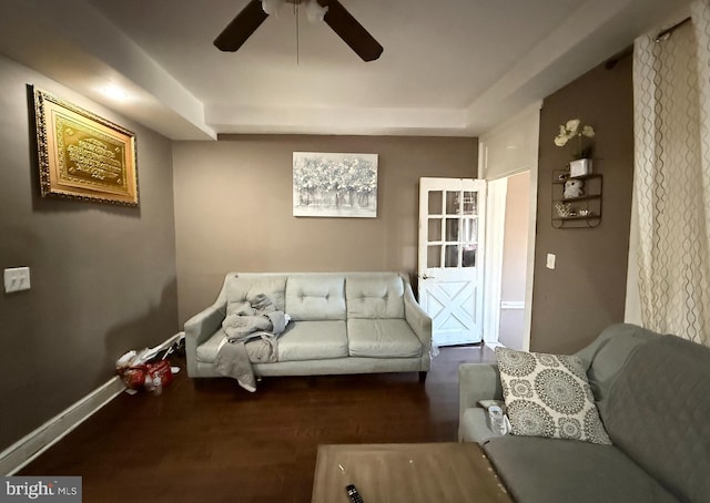 living area with ceiling fan and dark hardwood / wood-style flooring