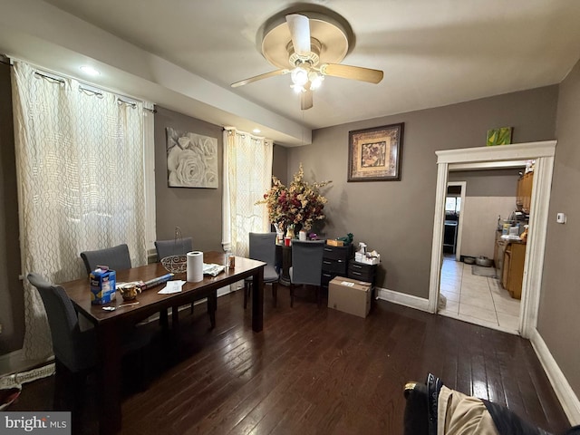 home office with ceiling fan and dark wood-type flooring