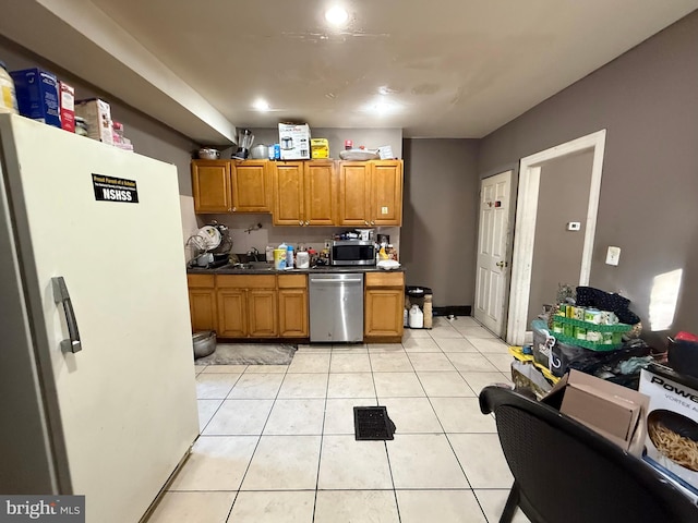 kitchen featuring sink, light tile patterned flooring, and appliances with stainless steel finishes