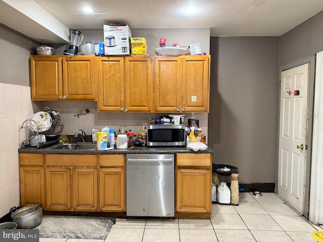 kitchen featuring sink, stainless steel appliances, and light tile patterned flooring