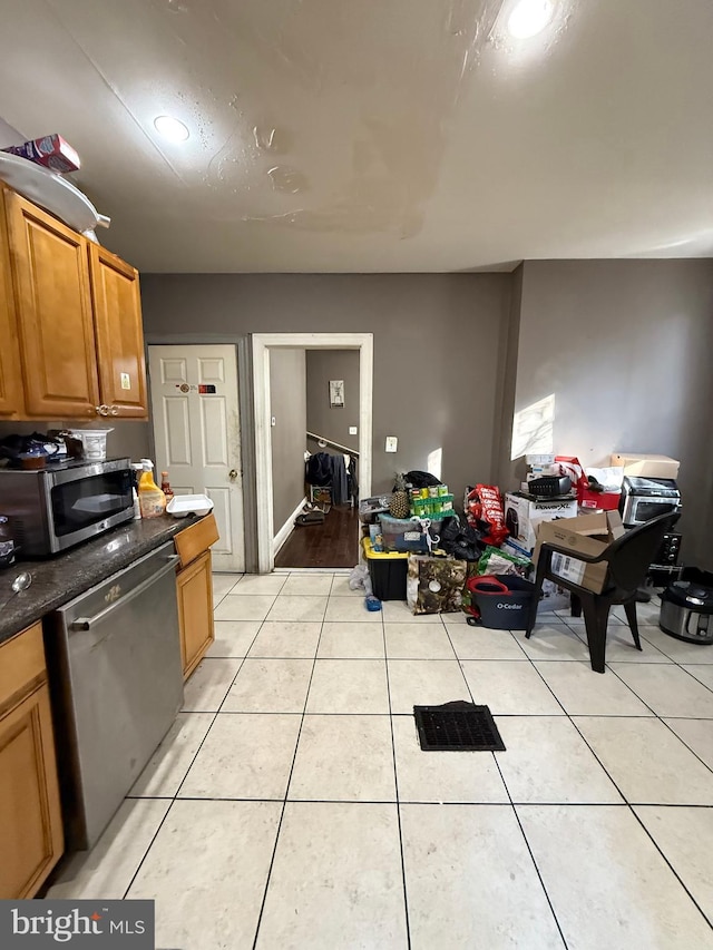 kitchen with appliances with stainless steel finishes and light tile patterned floors