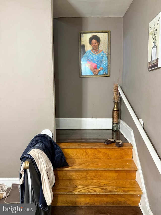 stairs featuring wood-type flooring