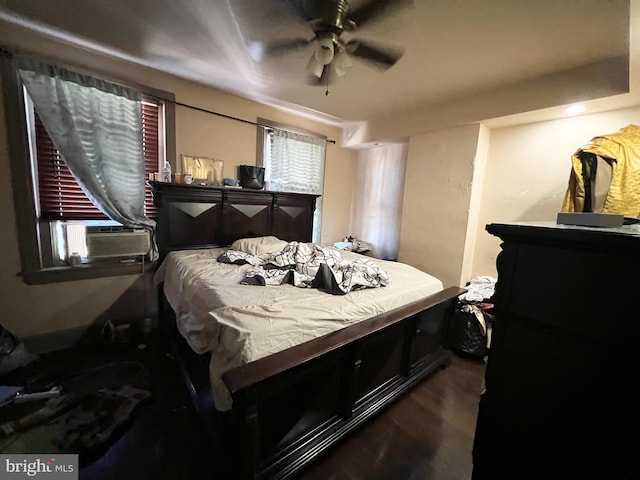 bedroom featuring ceiling fan, cooling unit, and wood-type flooring