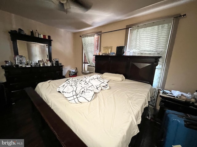 bedroom with ceiling fan and cooling unit