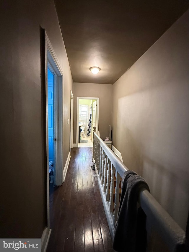 hall with dark hardwood / wood-style flooring