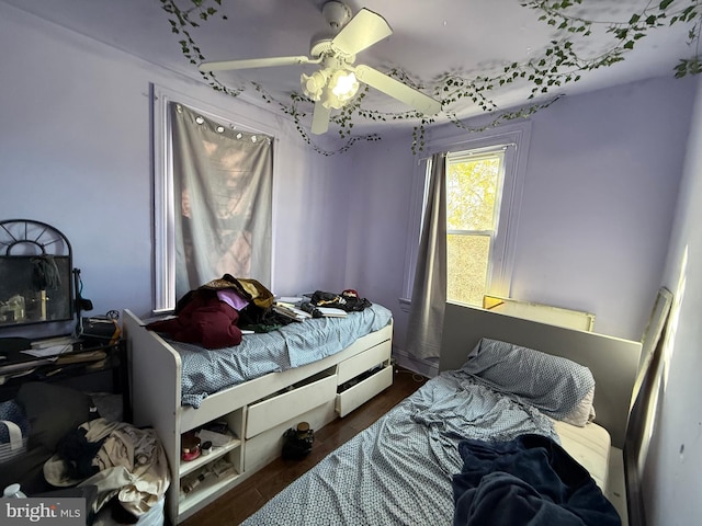 bedroom with ceiling fan and dark hardwood / wood-style floors