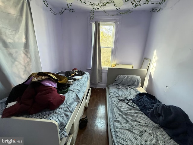 bedroom with dark hardwood / wood-style flooring