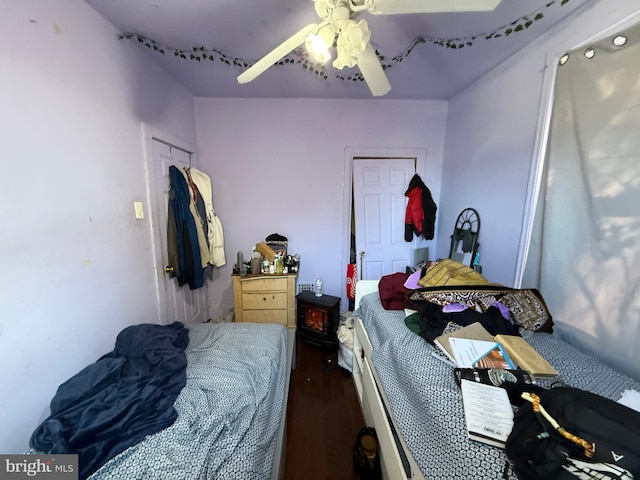 bedroom with ceiling fan and wood-type flooring