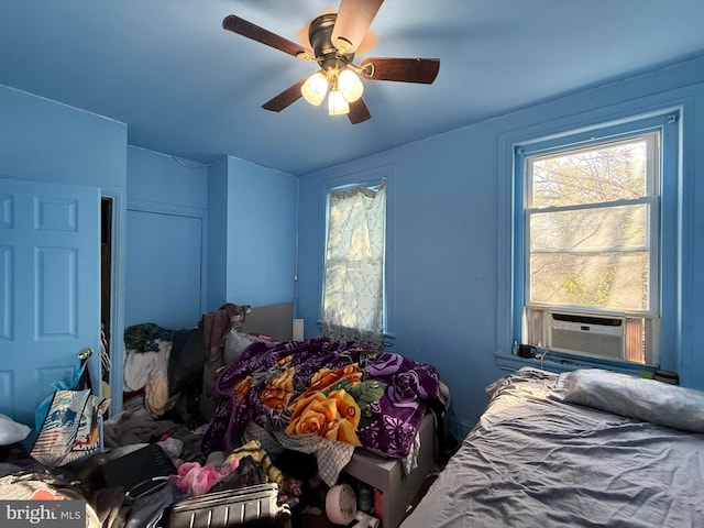 bedroom featuring ceiling fan and cooling unit