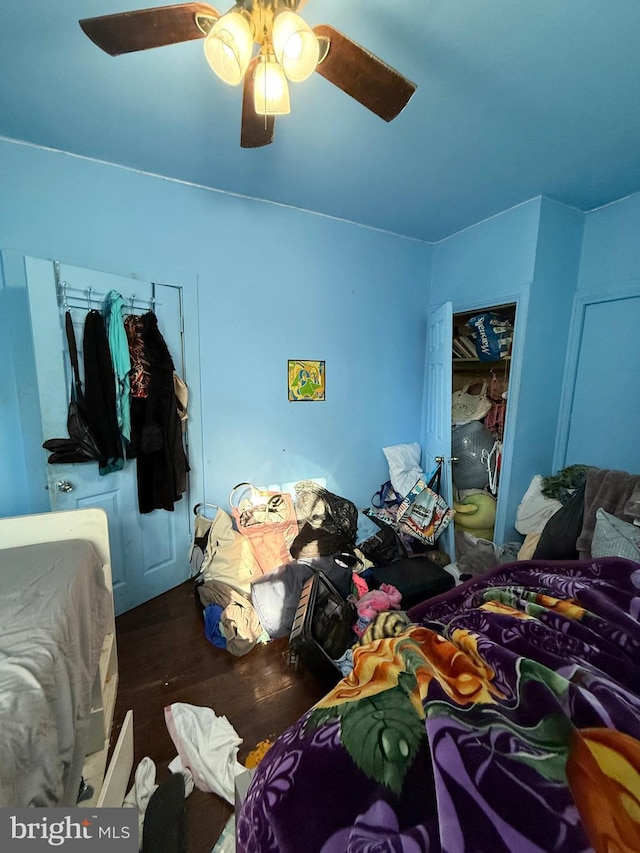 bedroom with ceiling fan and dark wood-type flooring