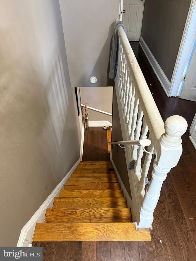 stairs featuring wood-type flooring