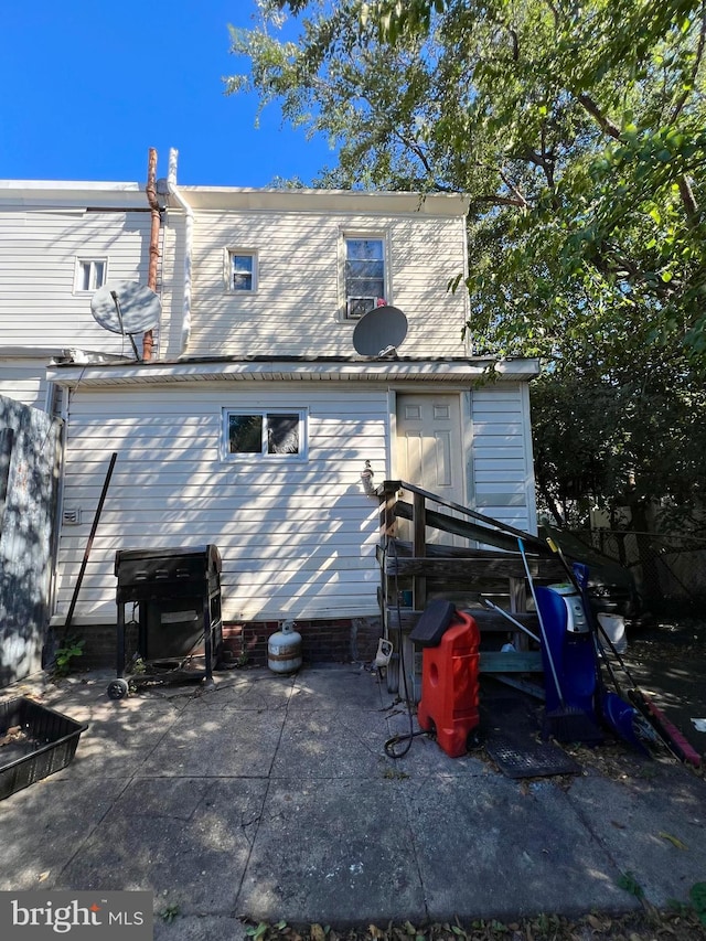 rear view of property featuring a patio