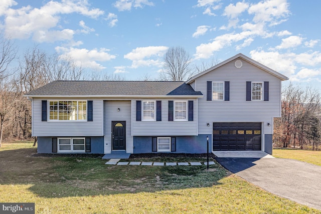 split foyer home with a garage and a front lawn