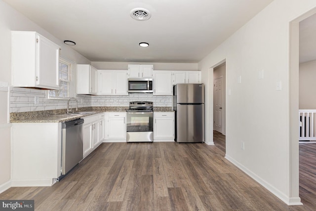 kitchen with white cabinets, sink, dark wood-type flooring, and appliances with stainless steel finishes