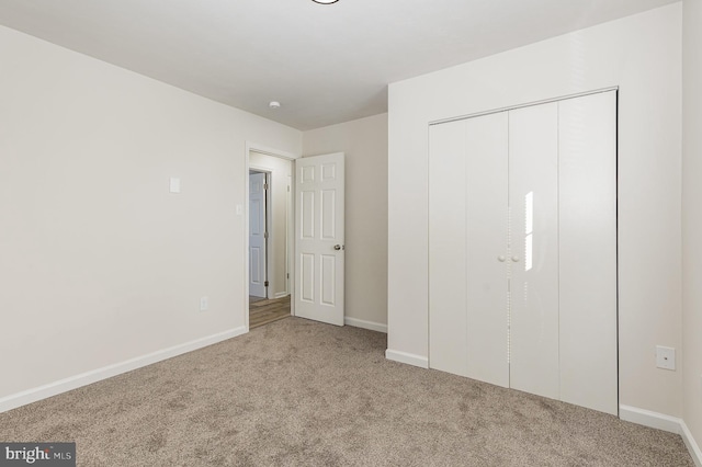 unfurnished bedroom with carpet floors and a closet