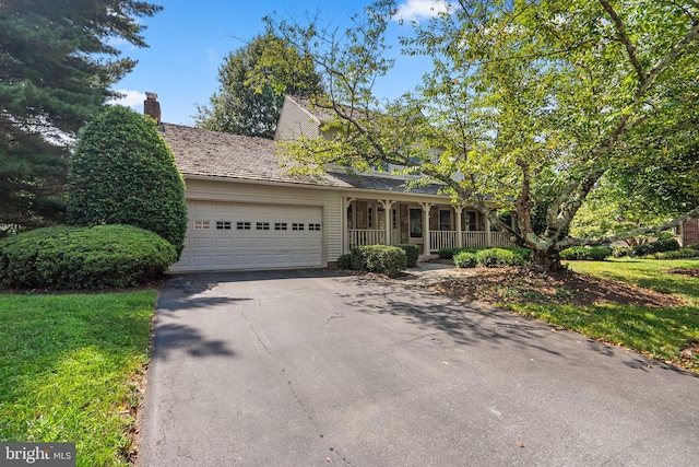 view of front of house featuring covered porch and a garage