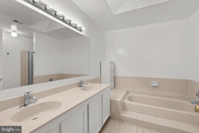 bathroom featuring tile patterned flooring, vanity, and a bathing tub