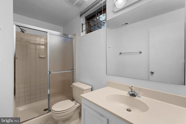 bathroom featuring vanity, toilet, tile patterned flooring, and walk in shower