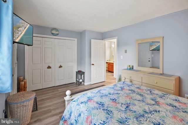 bedroom featuring light wood-type flooring and a closet