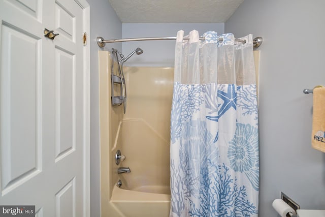 bathroom featuring shower / bath combo and a textured ceiling