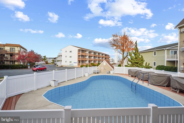 view of swimming pool featuring a patio area