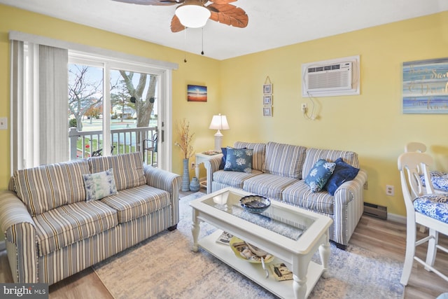 living room with ceiling fan, a baseboard radiator, and light hardwood / wood-style floors