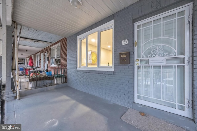 entrance to property featuring cooling unit and covered porch