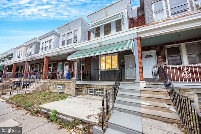 townhome / multi-family property featuring a porch