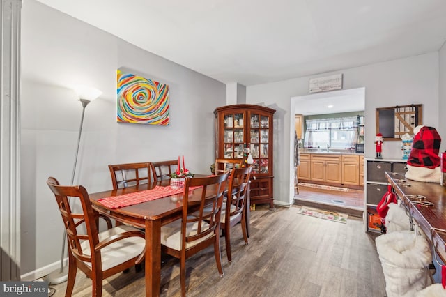 dining space with dark hardwood / wood-style flooring