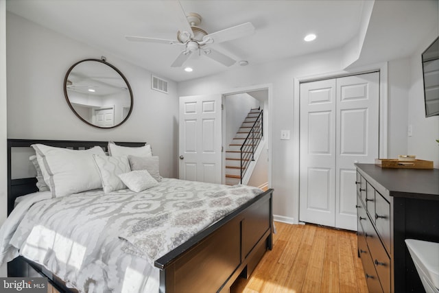 bedroom featuring light wood-type flooring, a closet, and ceiling fan