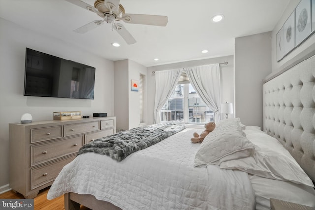 bedroom with ceiling fan and light hardwood / wood-style flooring