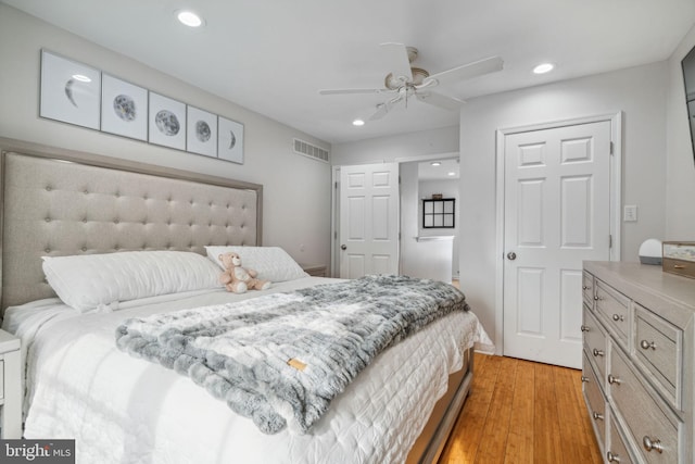 bedroom with ceiling fan and light hardwood / wood-style floors