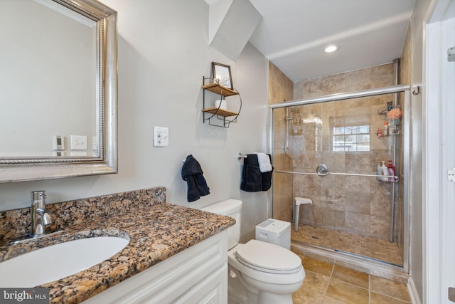 bathroom with tile patterned floors, vanity, toilet, and an enclosed shower