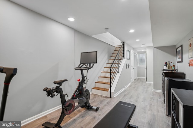 workout area with light hardwood / wood-style floors