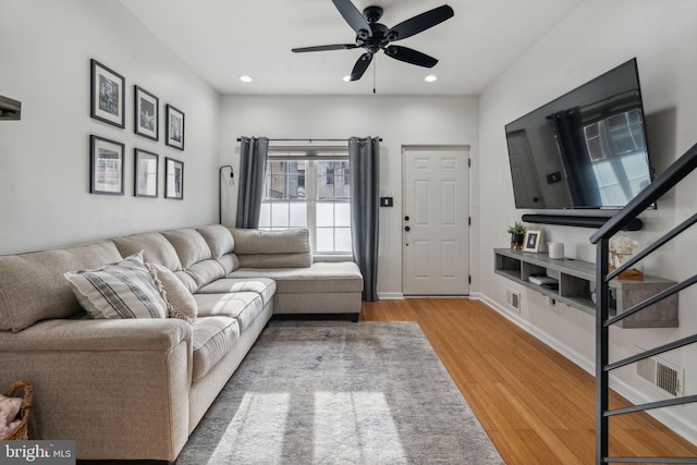 living room with ceiling fan and wood-type flooring