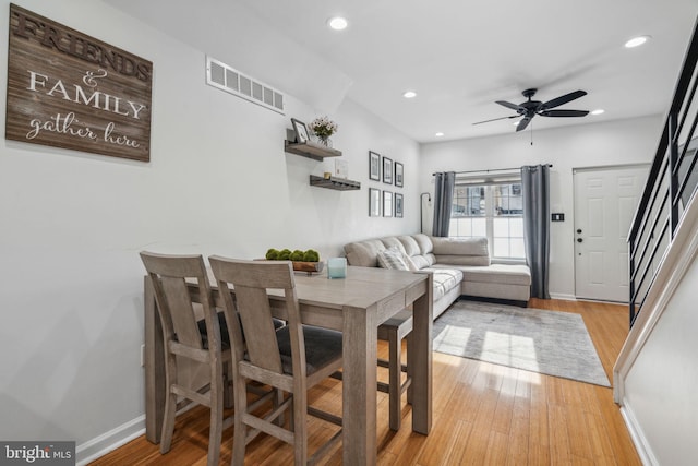 dining room with ceiling fan and light hardwood / wood-style floors