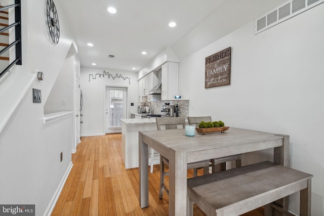 dining room with light hardwood / wood-style flooring and sink