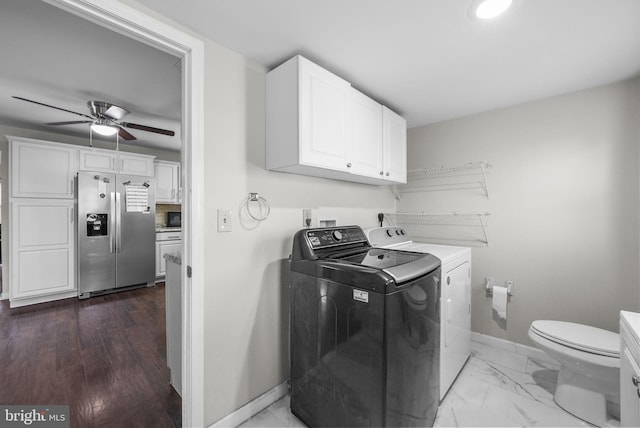 laundry area with hardwood / wood-style floors, washer and dryer, and ceiling fan