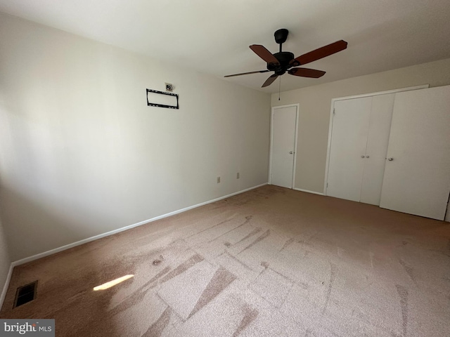 unfurnished bedroom with ceiling fan and carpet